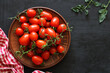 cherry tomatoes on a clay bowl, top view. ripe fresh vegetables. copy space.