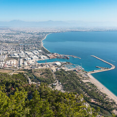 Wall Mural - top view of the bay and resort Turkish city of Antalya against the backdrop of mountains and blue sky