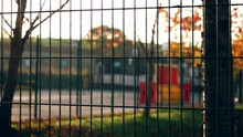 Metal Fence Surrounds School Park Playground