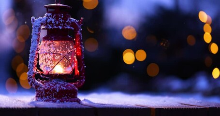 Wall Mural - Snow-covered lamp with fire on a wooden background. Falling snow slow motion effect