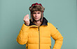 adult man making capice or money gesture, telling you to pay wearing anorak. winter and cold concept