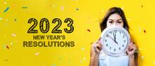 2023 New Years Resolutions With Young Woman Holding A Clock Showing Nearly 12