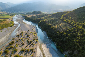 Wall Mural - Aerial view of river Osumi by village Mbrakull near Polican in Albania in Summer sunrise