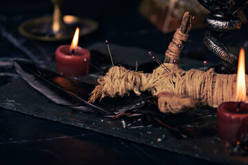 Wall Mural - Voodoo doll in ritual scene close up, magic table with candles, witchcraft and spirituality concept.