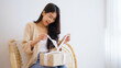 © Monster Ztudio - Asian young woman opening a gift box. Happy new year, Thanksgiving