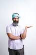 © Niks Ads - Indian farmer Standing on white background and showing direction with hand.