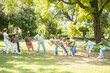 © GAJENDRRA BHATI  - Group Of Senior Indian People Playing Tug War Outdoor In Park. Retirement life.
