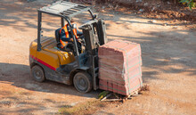 A Forklift Carrying A Paving Stone