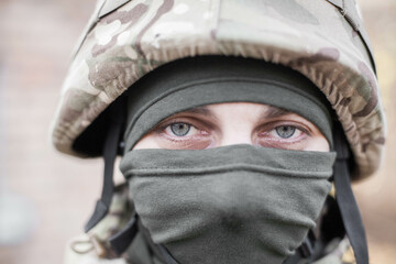 Wall Mural - A military man from Ukraine, in uniform on the street with a weapon