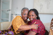 © Cultura Creative - Smiling senior woman hugging teenage granddaughter at home