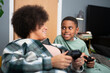 © Cultura Creative - Mother and son playing video games at home