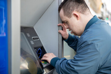 Man using cash machine in street