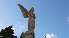 Statue Of An Angel With Clouds Timelapse In The Background