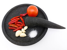 Red Chilies, Garlics, Tomato, And Salt On Stone Ware,  Ingredients For Making Traditional Indonesian Sambal Tomat Or Spicy Tomato Sauce. Isolated On White Background. Top View.