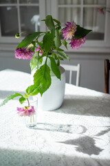 Wall Mural - Variety of flowers in a vase on a wooden table in a vintage style room