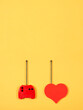 remote control together with a red heart, on a yellow background, control emotions or feelings
