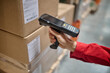 Warehouse employee scanning packaging information using a scanner