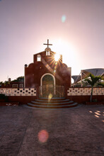 Sunset Golden Hour With Red Catholic Church In El Cuyo, Mexico.