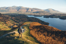 Hiker Standing On Catbells Looking Out Over Derwent Water At Sunrise. Easy Walks Near Keswick.  Cumbria