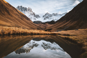 Wall Mural - Small water pond in Juta valley in autumn season, Caucasus mountains range in Georgia country, Europe