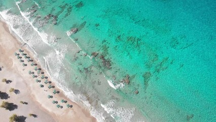 Wall Mural - Beautiful view of sun umbrellas on sandy beach at sea coast during sunny summer day