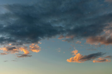 Wall Mural - dark rain clouds backlit by the evening sun as a natural background