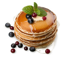 Wall Mural - Stack of Small pancakes in syrup and berries on background