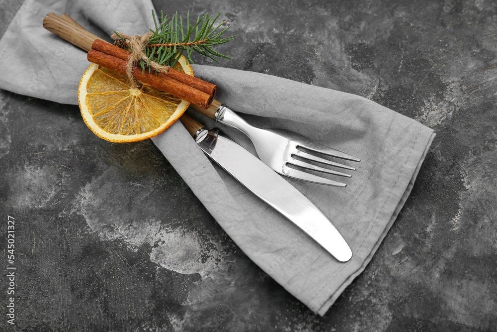 Stylish table setting for Christmas celebration on grunge background, closeup