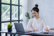 © ArLawKa - young businessman asian girl Work on laptop at work Small Business Startup Online Banking Tax Accounting Financial Concepts