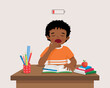 cute little African boy yawning feeling sleepy while studying doing homework on the desk