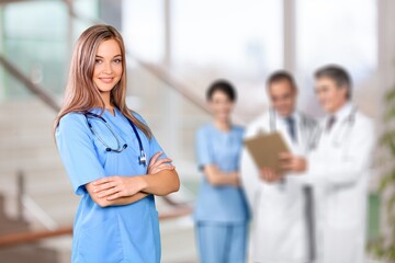 Wall Mural - Cute young nurse at medical staff meeting.