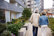 © Johnér - Senior couple holding hands in residential area