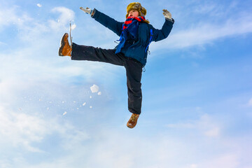 Happy boy jump outdoors. A boy plays outside in winter. Winter fun activity outdoor, winter vacation. Family time