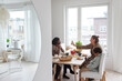 © Johnér - Family sitting at table and eating breakfast