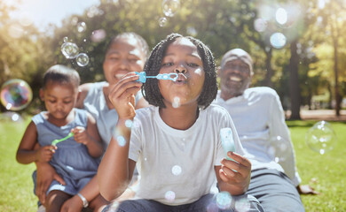 happy, nature and black family blowing bubbles while playing, bonding and enjoying summer in the par