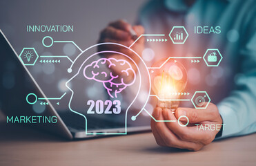 Poster - 2023 Creativity in the hands of business people idea concept, hand holding glowing light bulb with drawing brain and connection line, creative thinking ideas and innovation technology and creativity