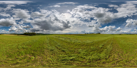 Wall Mural - full seamless hdri 360 panorama among farming field with cut grass and clouds in overcast sky in equ