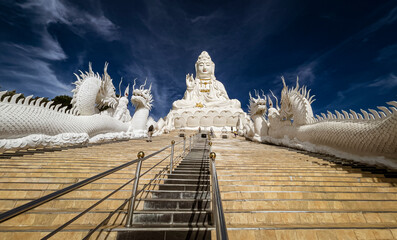 The Temple of Mercy (Guanyin) in Chiang Rai, Thailand sits on top of a mountain is entirely white.