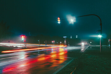 Wall Mural - Traffic lights on a traffic junction in a rainy night