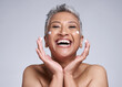 © N F/peopleimages.com - Face, cream and happy senior portrait of woman with luxury dermatology product dots and playful smile. Anti aging, care and cosmetic lifestyle model with skincare beauty on gray studio mockup.