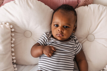 close-up portrait of cute black baby with slobber around mouth