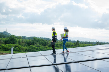 Poster - Technician wearing safety harness belt during installing the solar panels on roof structure of building factory,Economic energy and cost saving concept.