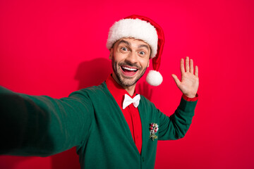 Poster - Photo of excited funky guy dressed xmas green cardigan waving arm tacking selfie isolated red color background