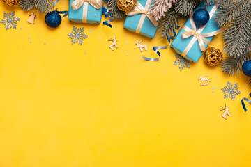 Christmas background with pine tree, gifts and festive decorations in Ukraine colors top view. Christmas flat lay.