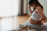 Fototapeta  - Pregnant woman calling medical assistance