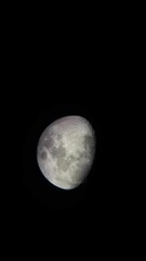 Sticker - Vertical zoomed-in shot of the moon in the night sky