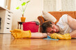© Teodor Lazarev - Man exhausted from work sleeping on the floor in the middle of the cleaning job