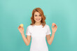© Olena - happy woman hold sweet macaron french cookie on blue background