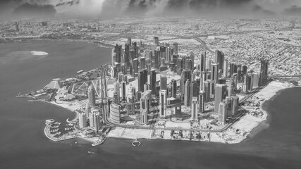 Wall Mural - Aerial view of Doha skyline from airplane during a storm. Corniche and modern buildings, Qatar