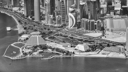 Canvas Print - Aerial view of Doha skyline from airplane. Corniche and modern buildings, Qatar